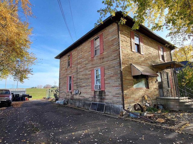 view of side of home with cooling unit