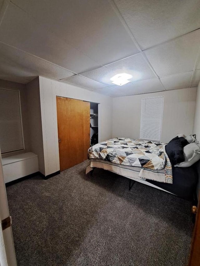 carpeted bedroom featuring a paneled ceiling