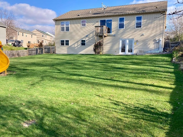 rear view of property featuring a yard