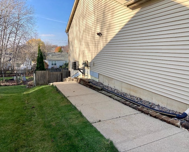 view of home's exterior with a yard and central AC