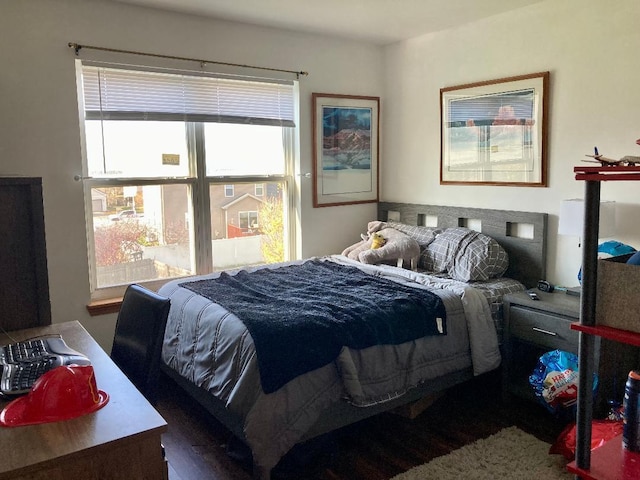 bedroom with dark wood-type flooring