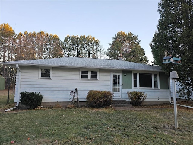 ranch-style home with a front lawn