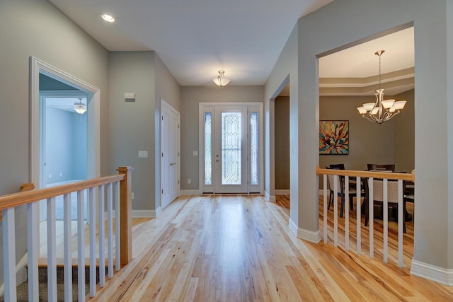 entrance foyer featuring an inviting chandelier and light wood-type flooring