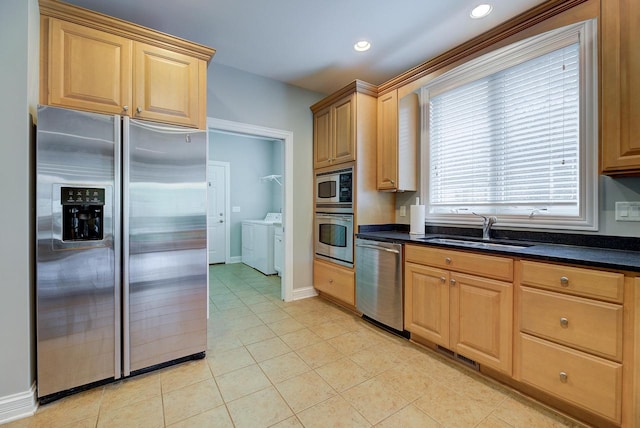 kitchen featuring light brown cabinets, independent washer and dryer, stainless steel appliances, and sink