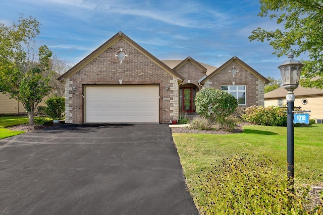 view of front of property with a front yard and a garage