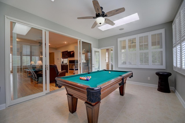 game room featuring ceiling fan, a skylight, billiards, and light tile patterned floors