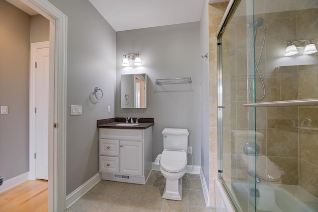 full bathroom with vanity, toilet, tile patterned flooring, and bath / shower combo with glass door