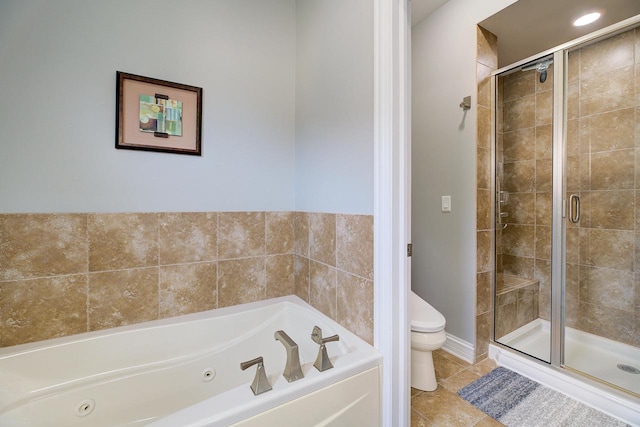 bathroom featuring tile patterned flooring, toilet, and shower with separate bathtub