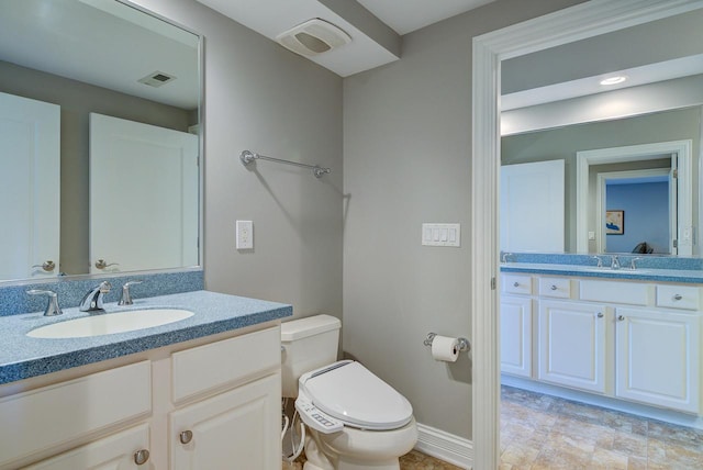 bathroom with toilet and vanity