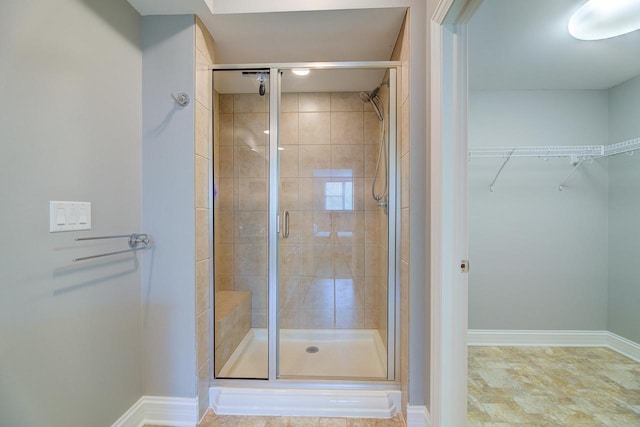 bathroom featuring a shower with door