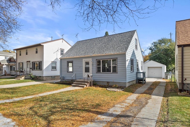 bungalow-style home with a front lawn, an outbuilding, and a garage