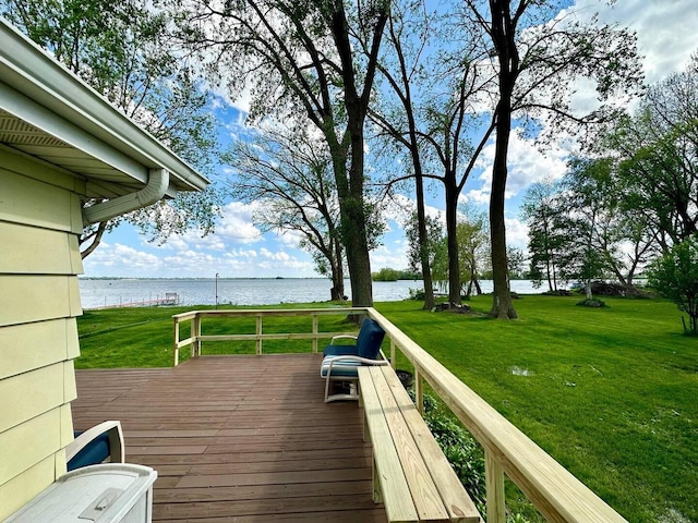 wooden terrace featuring a yard and a water view