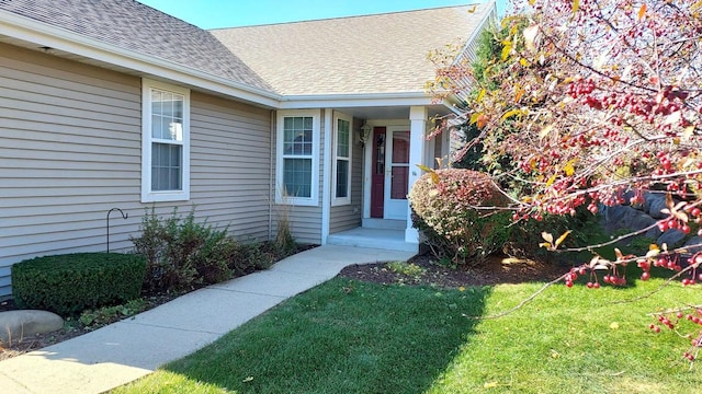 property entrance featuring a lawn