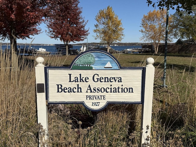 community / neighborhood sign with a water view