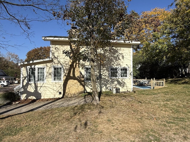 rear view of house with a lawn and cooling unit