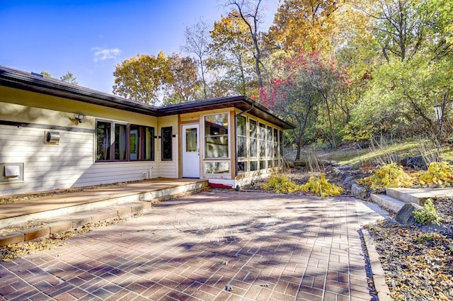 exterior space with a patio area and a sunroom