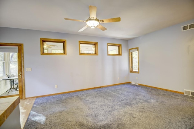 carpeted empty room featuring ceiling fan