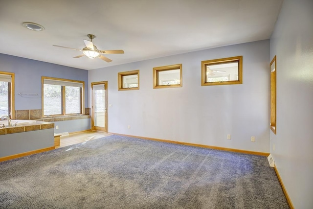 carpeted spare room with ceiling fan