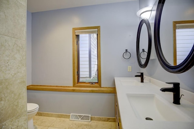 bathroom featuring vanity, toilet, and tile patterned flooring