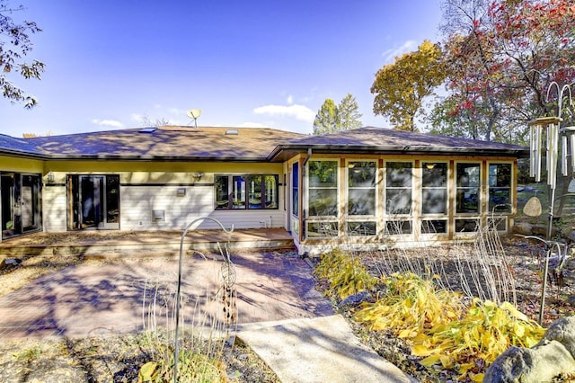 rear view of property with a sunroom