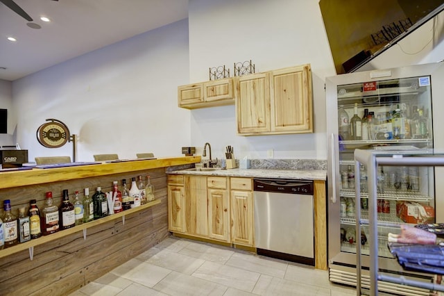 kitchen with light brown cabinets, stainless steel appliances, sink, light tile patterned floors, and ceiling fan