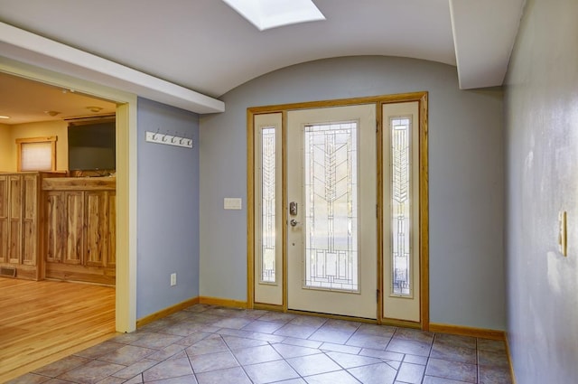 foyer featuring light hardwood / wood-style floors and a skylight