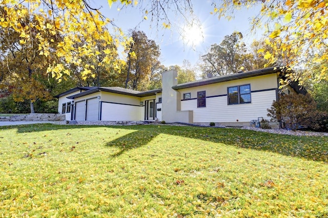 ranch-style home featuring a front yard and a garage