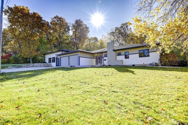 ranch-style home with a front yard and a garage