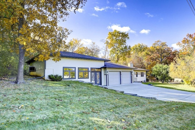 ranch-style home featuring a garage, a front lawn, and central AC unit