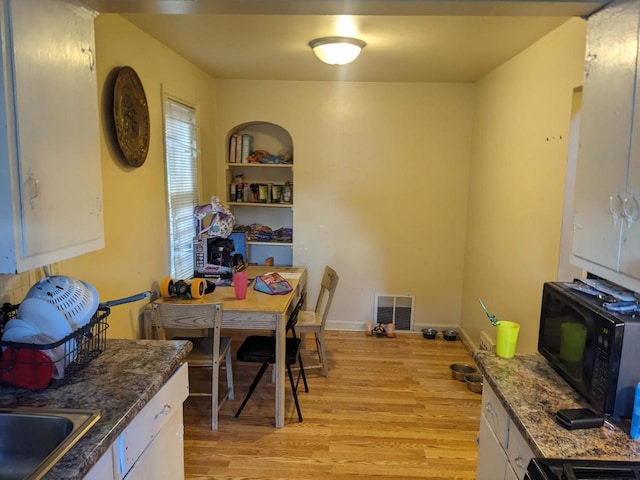 dining area featuring light hardwood / wood-style flooring and sink