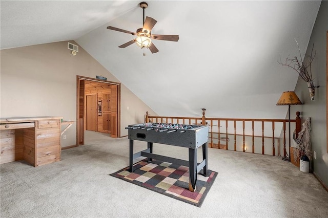 game room with vaulted ceiling, light colored carpet, and ceiling fan