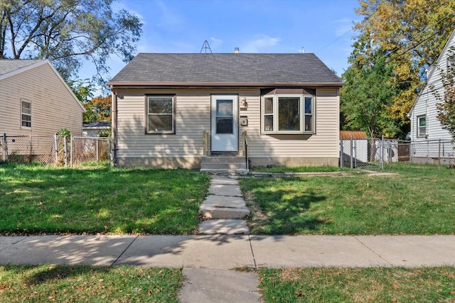 bungalow-style home featuring a front yard