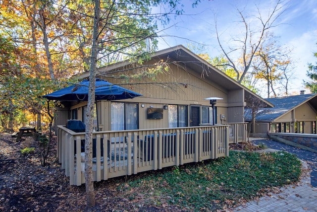 rear view of property with a wooden deck