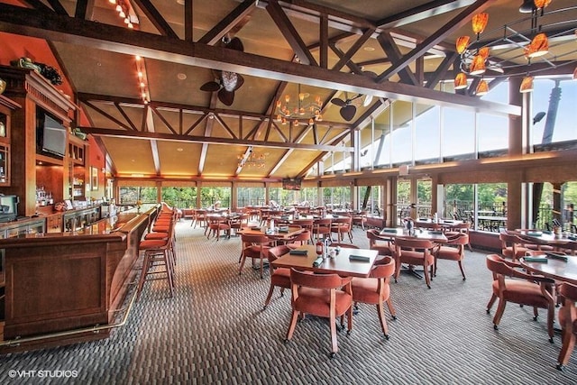 dining space with beamed ceiling, plenty of natural light, high vaulted ceiling, and carpet