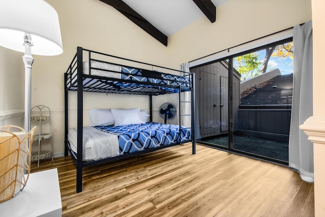 bedroom featuring vaulted ceiling with beams and hardwood / wood-style flooring