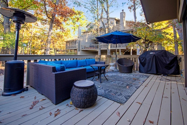 wooden terrace featuring an outdoor living space and area for grilling