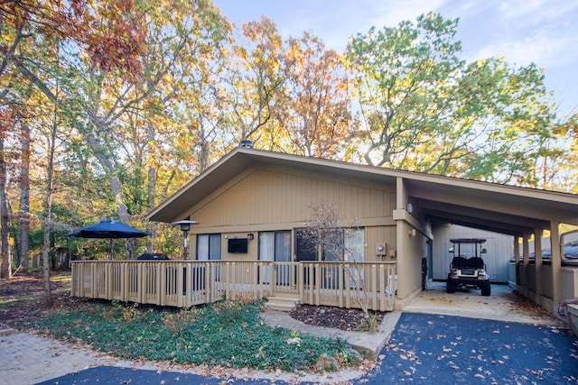 view of front of house with a wooden deck and a carport