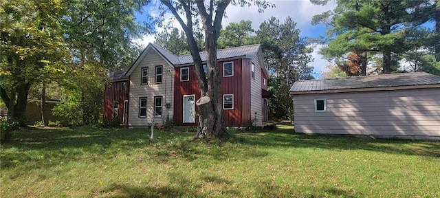 back of property with a lawn and metal roof