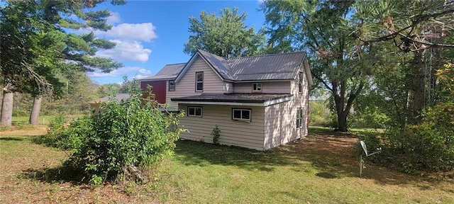 view of property exterior with a lawn