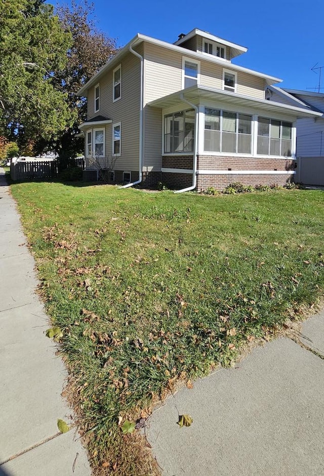 view of front of property with a front lawn and a sunroom