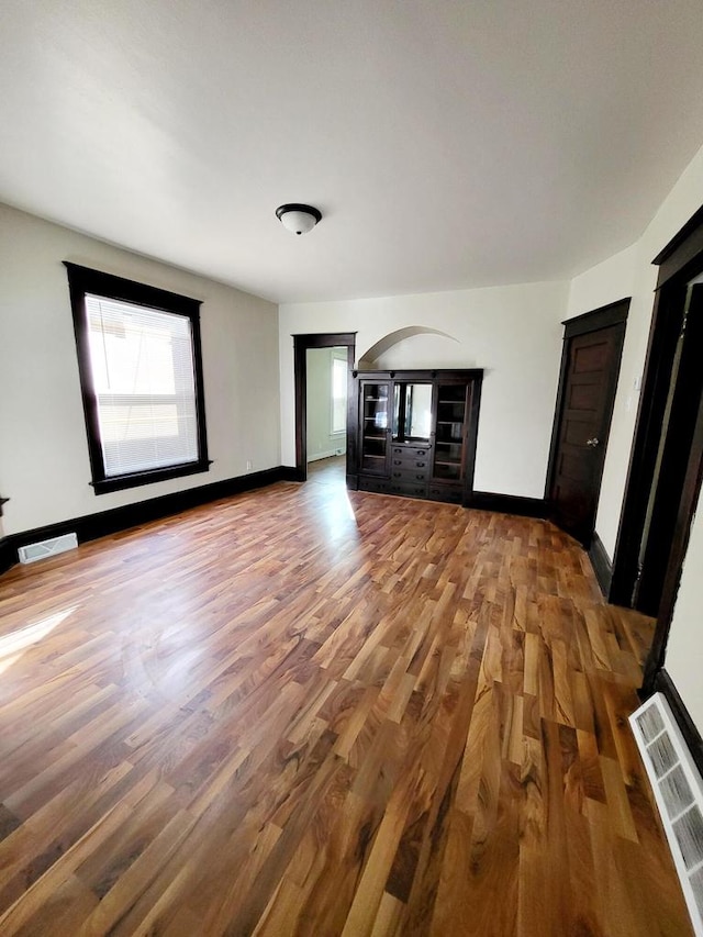 unfurnished living room featuring wood-type flooring