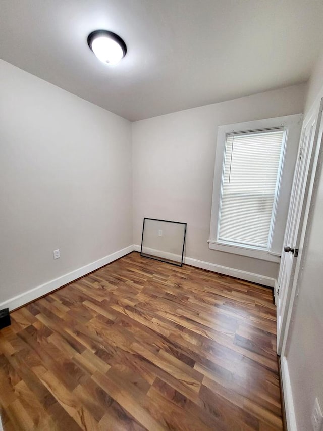 spare room with dark hardwood / wood-style flooring