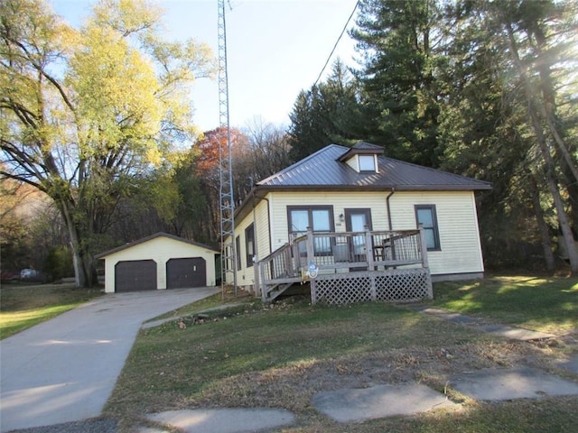 bungalow with an outdoor structure, a front lawn, and a garage