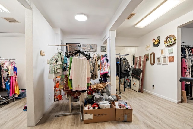 spacious closet with light hardwood / wood-style flooring