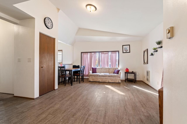 unfurnished living room with hardwood / wood-style flooring and lofted ceiling