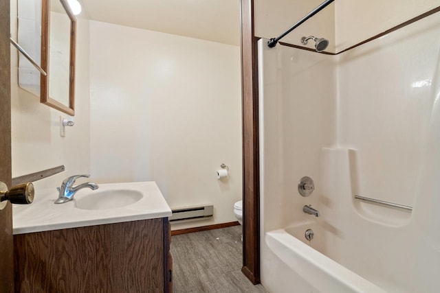 full bathroom featuring hardwood / wood-style floors, toilet, baseboard heating, vanity, and tub / shower combination