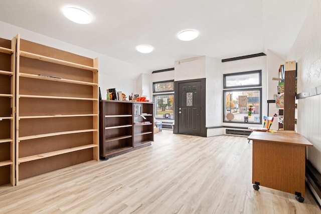 interior space featuring lofted ceiling and light wood-type flooring