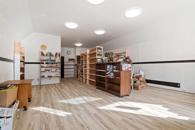 office with vaulted ceiling and light hardwood / wood-style floors