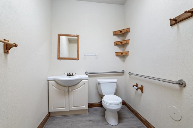 bathroom featuring vanity, toilet, and wood-type flooring