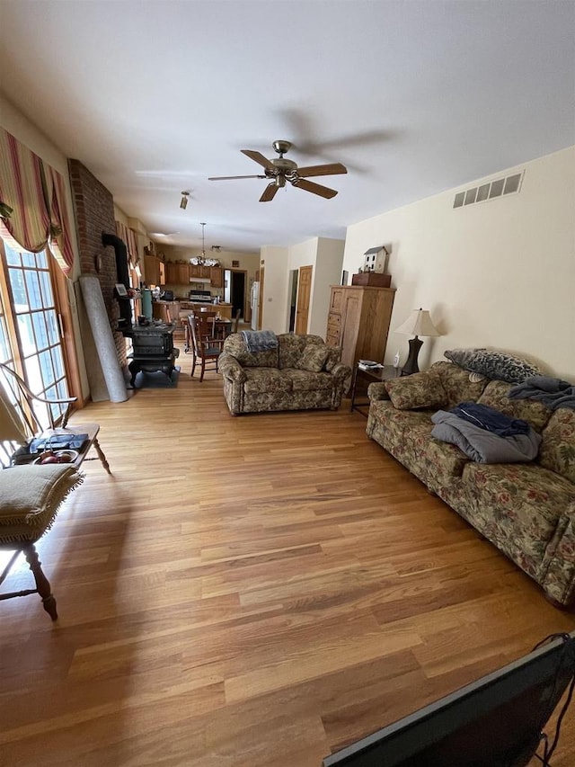 living room featuring light hardwood / wood-style flooring and ceiling fan